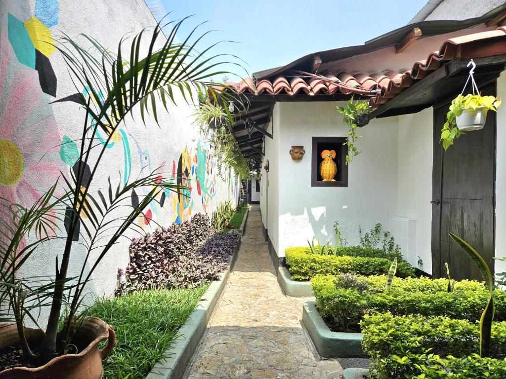 a garden with a wall with a painting on it at Hotel Casa Nikté in Antigua Guatemala