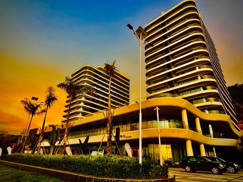 a large building with a car parked in front of it at Platinum Coast Hotel and condominium 