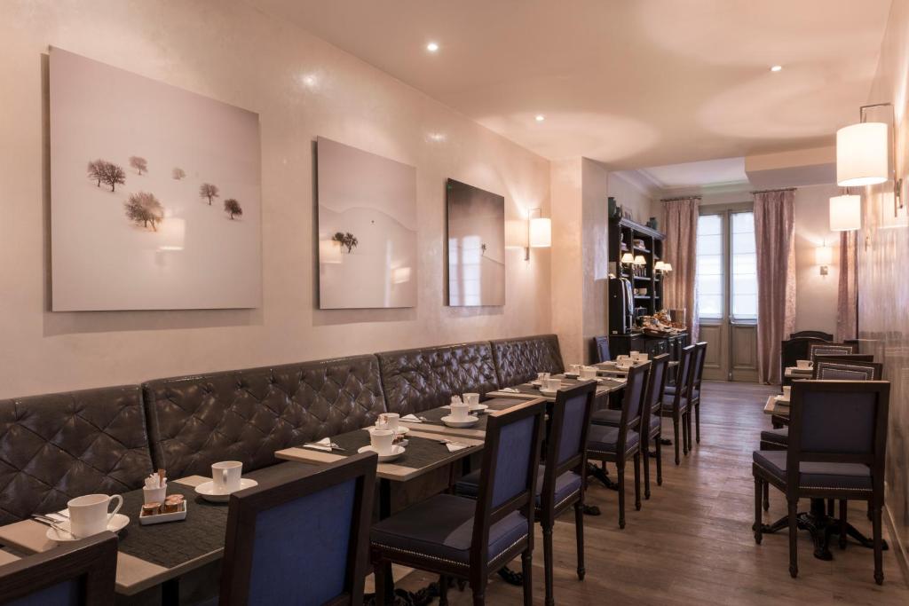 a row of tables and chairs in a restaurant at Magda Champs Elysées in Paris