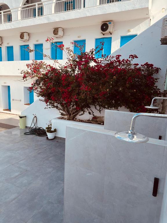 a bathroom with a sink in front of a building at Hotel Petradi in Ios Chora