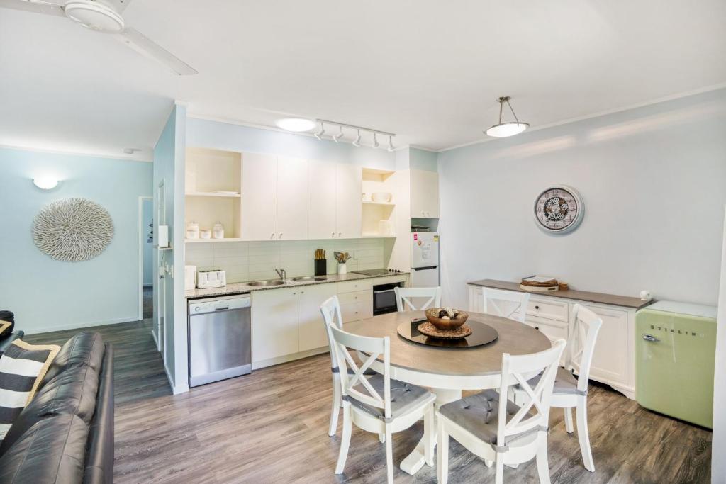 a kitchen and dining room with a table and chairs at Baden 58 - Rainbow Shores. Aircon. Wifi. Pools Walk to beach in Rainbow Beach