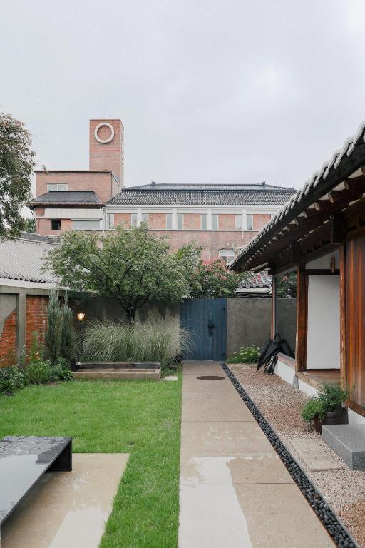 a courtyard with a building with a clock tower at Stay kkachi #center of Hanok village in Jeonju