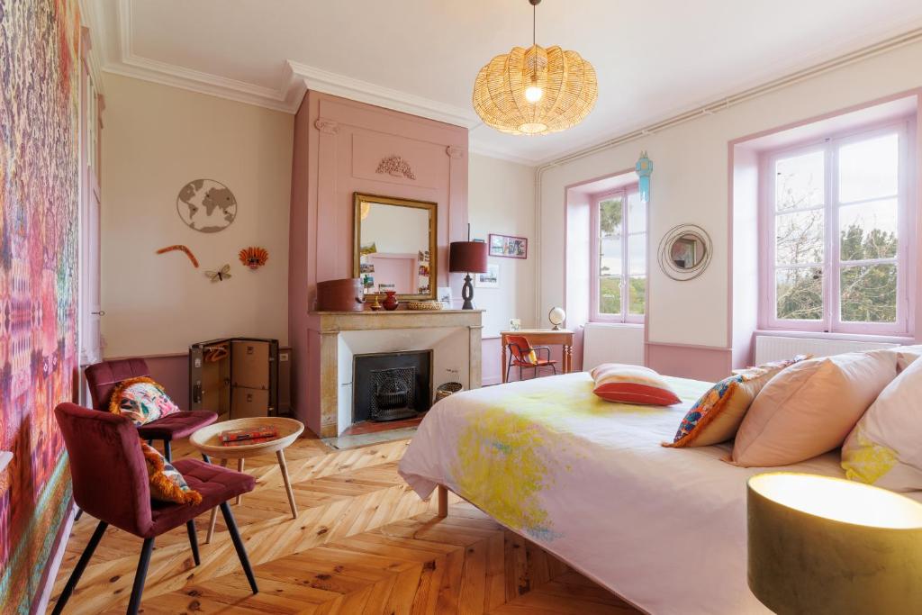 a bedroom with a bed and a fireplace at Château de Bourrassol in Ménétrol