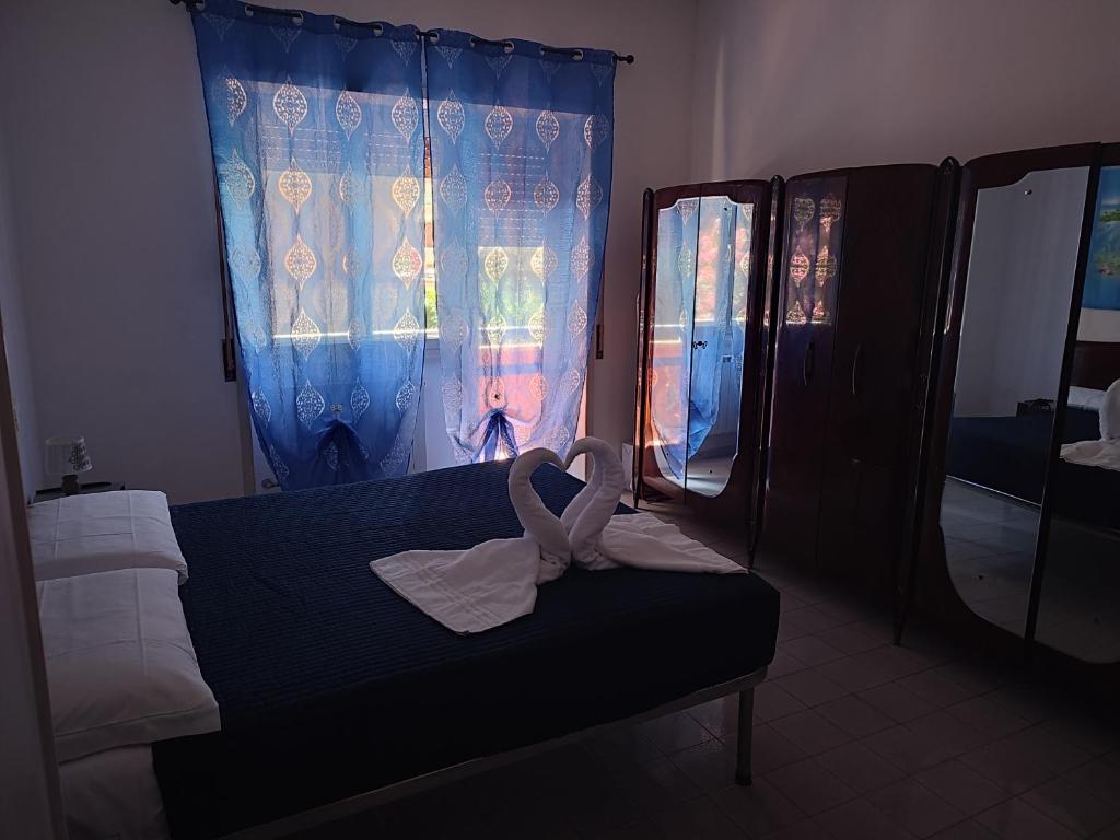a bedroom with a bed with a towel on it at Sun & Beach Vasco De Gama by ACS HOLIDAYS in Lido di Ostia