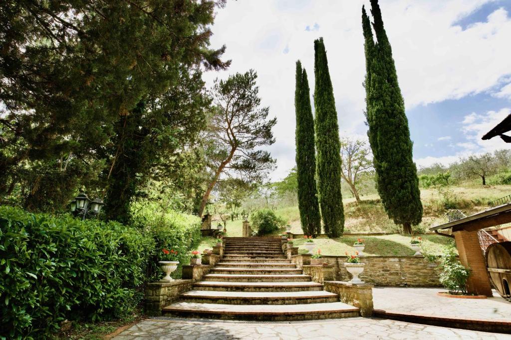 a set of stairs in a garden with trees at Beautiful country house in the heart of Tuscany in Capolona