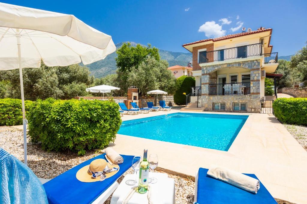 a villa with a swimming pool and a house at Golden Trio Villa in Oludeniz