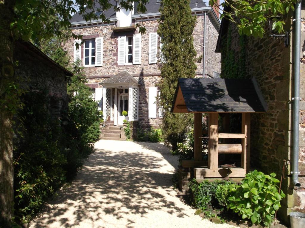 a stone house with a sign in front of it at La Sévinais in Retiers