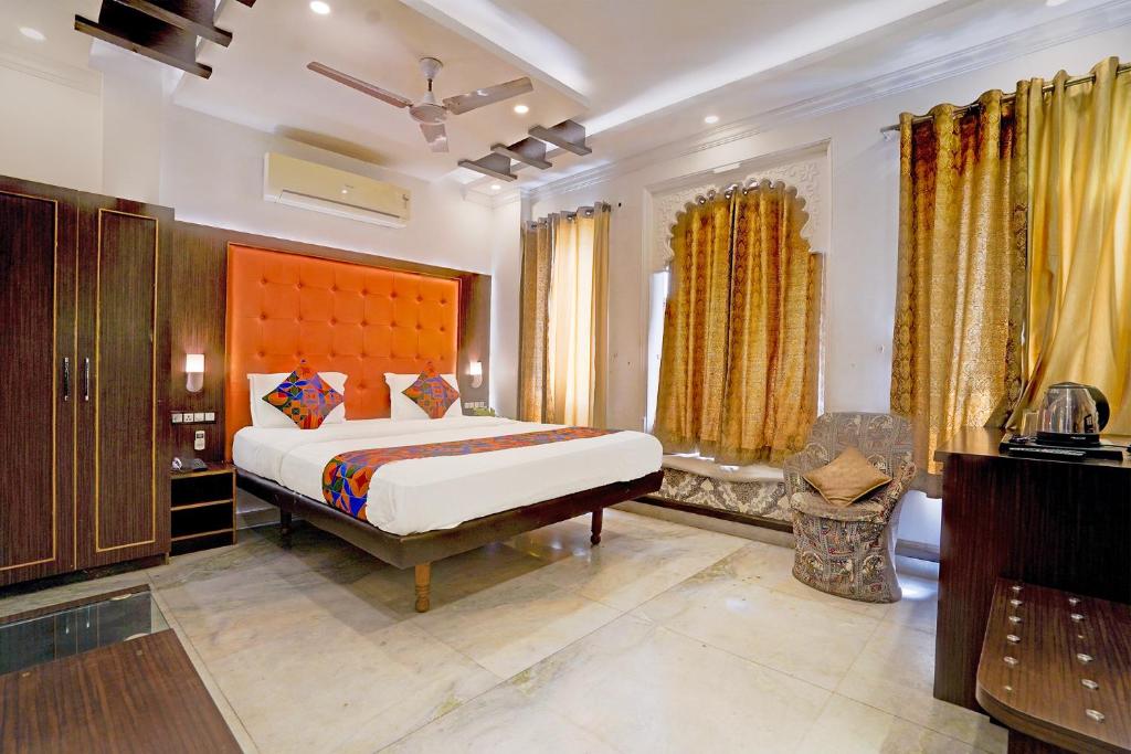 a bedroom with a large bed in a room at FabHotel Mandiram Palace in Udaipur