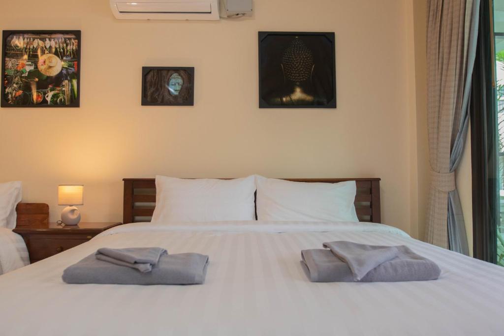 Postel nebo postele na pokoji v ubytování Maiiam Guesthouse Patong
