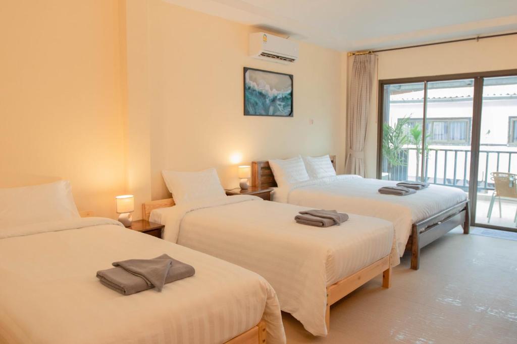 Postel nebo postele na pokoji v ubytování Maiiam Guesthouse Patong