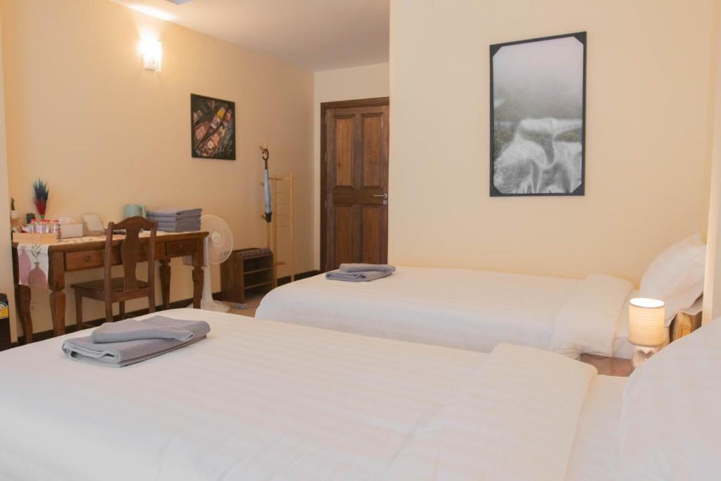 Postel nebo postele na pokoji v ubytování Maiiam Guesthouse Patong