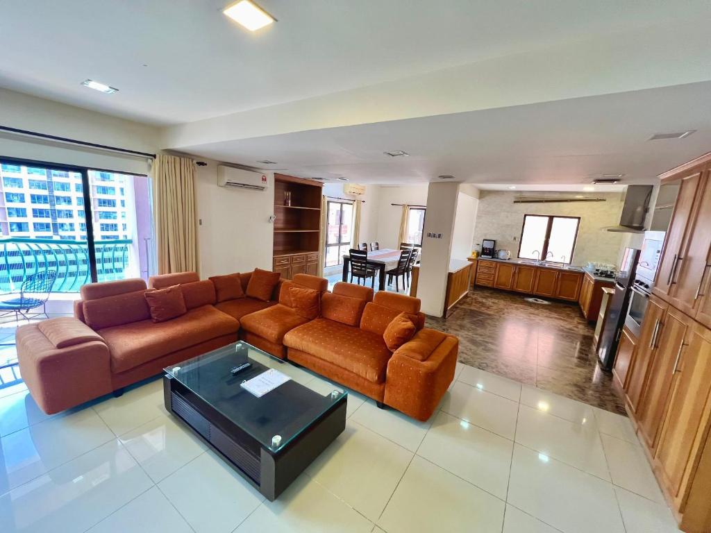a living room with a couch and a table at 4 Bedrooms PENTHOUSE MARINA COURT VACATION HOME KOTA KINABALU 14pax in Kota Kinabalu