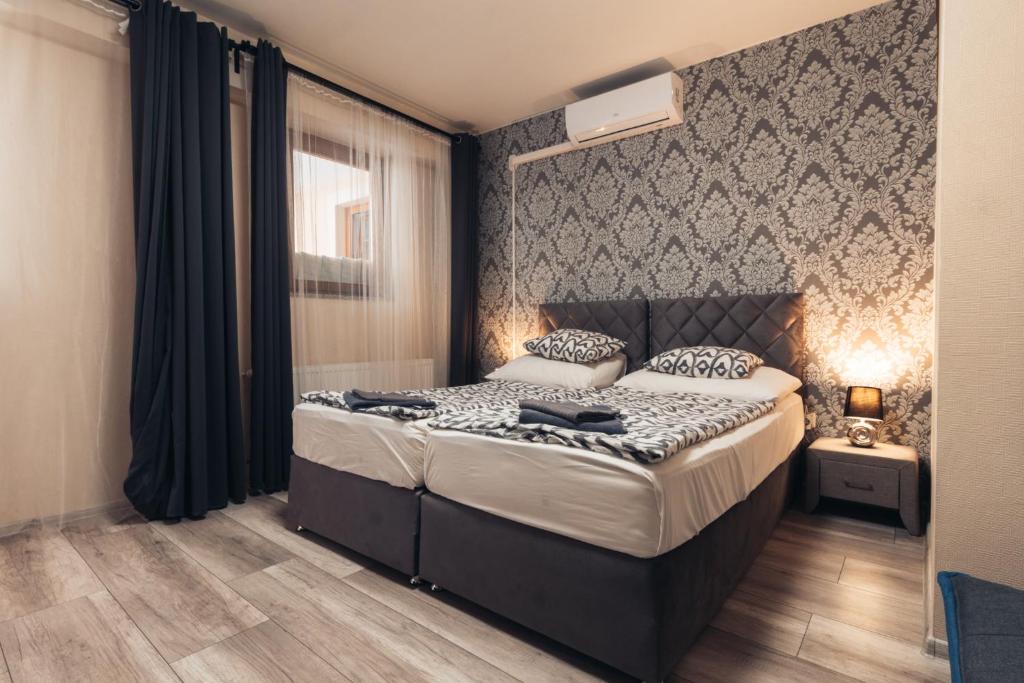 Végvári Hotel Eger في إغير: غرفة نوم بسرير كبير في غرفة