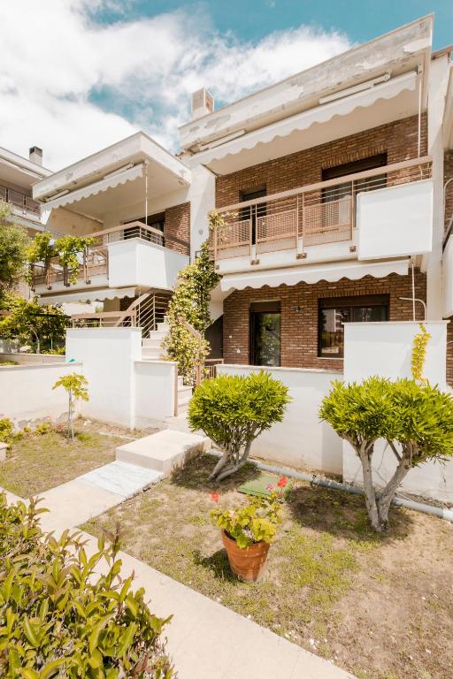 an apartment building with trees in front of it at Delmare Delia maisonette in Yerakiní