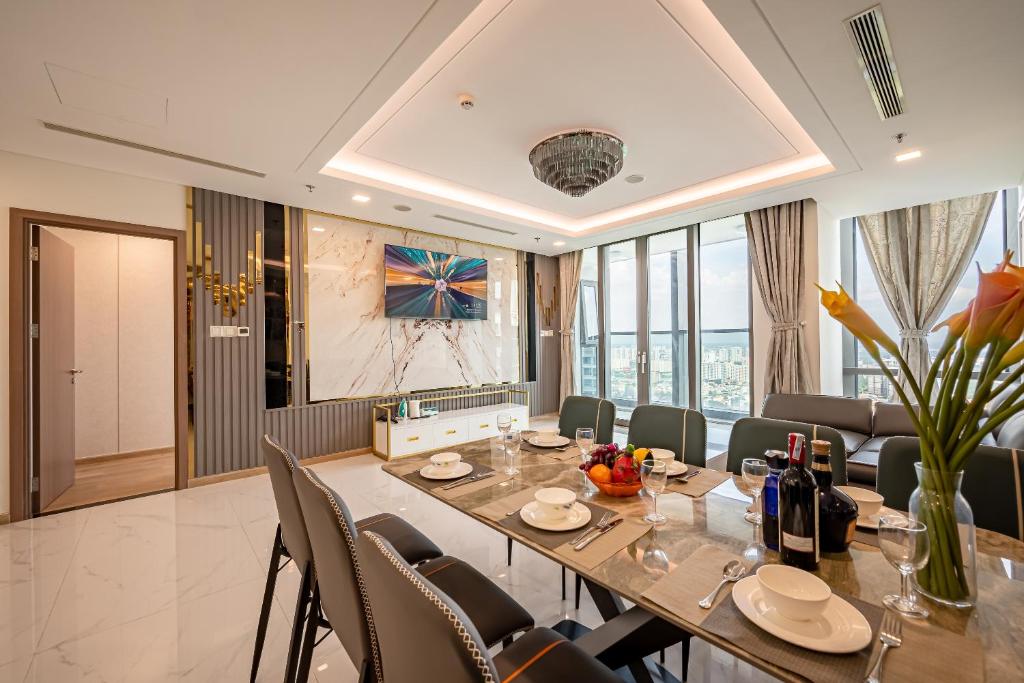 a dining room with a long table and chairs at Free Pickup Airport-LANDMARK 81 Condotel Center Suite in Ho Chi Minh City