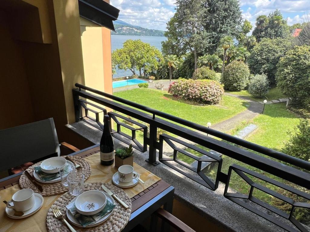 a table on a balcony with a view of the water at Sole e Lago in Stresa