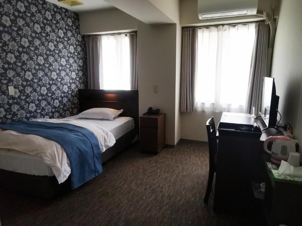 Postel nebo postele na pokoji v ubytování Business Hotel Azuma