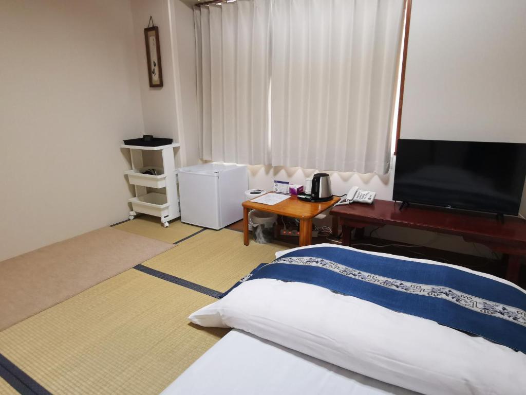 Postel nebo postele na pokoji v ubytování Business Hotel Azuma