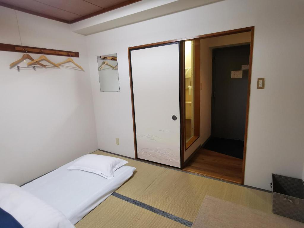 Postel nebo postele na pokoji v ubytování Business Hotel Azuma