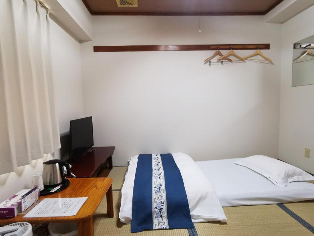Postel nebo postele na pokoji v ubytování Business Hotel Azuma