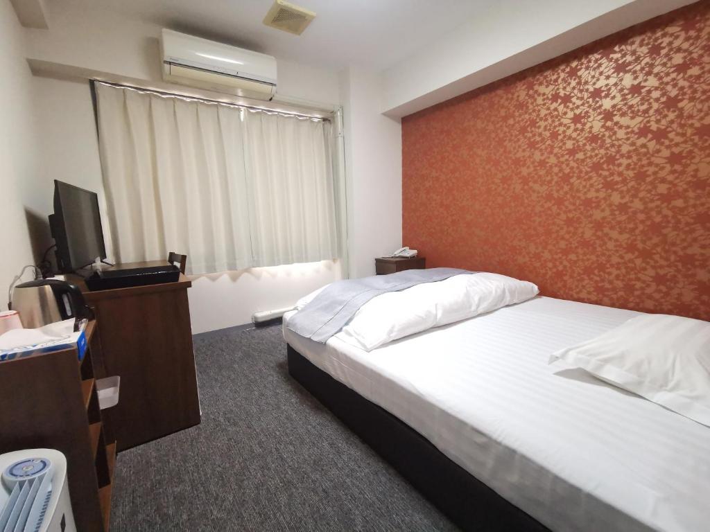 Postel nebo postele na pokoji v ubytování Business Hotel Azuma