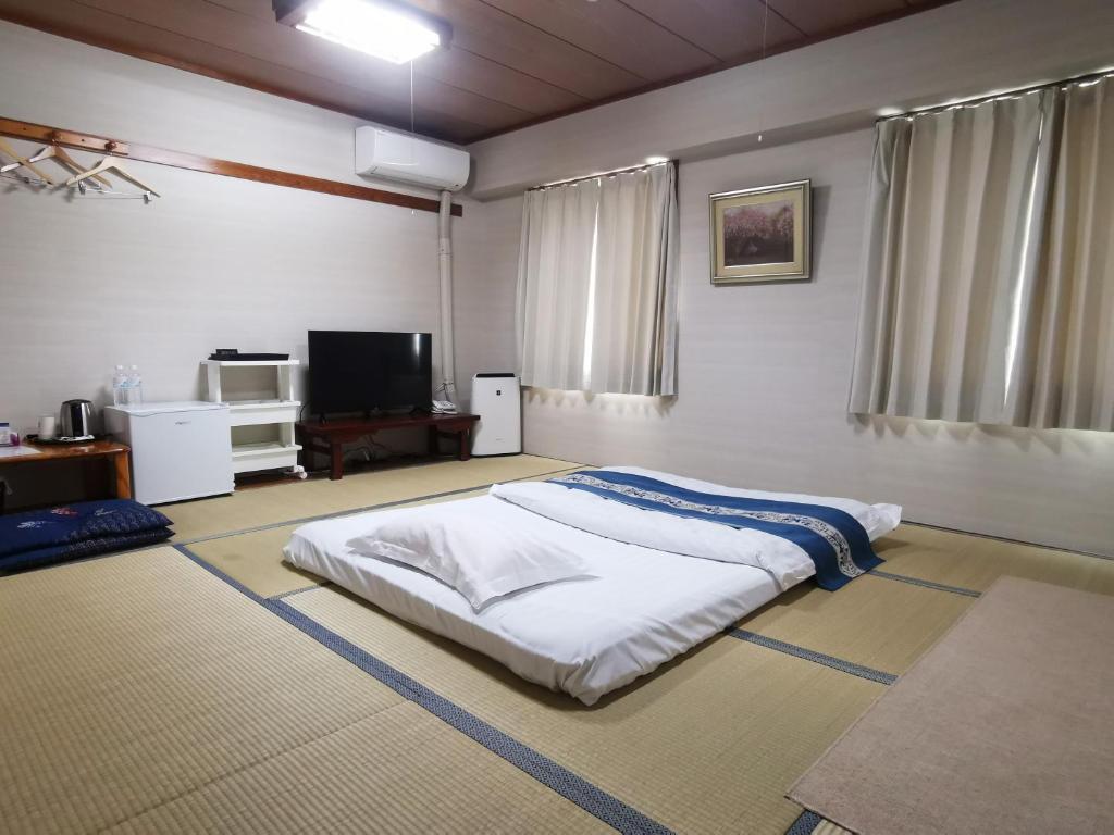 Postel nebo postele na pokoji v ubytování Business Hotel Azuma