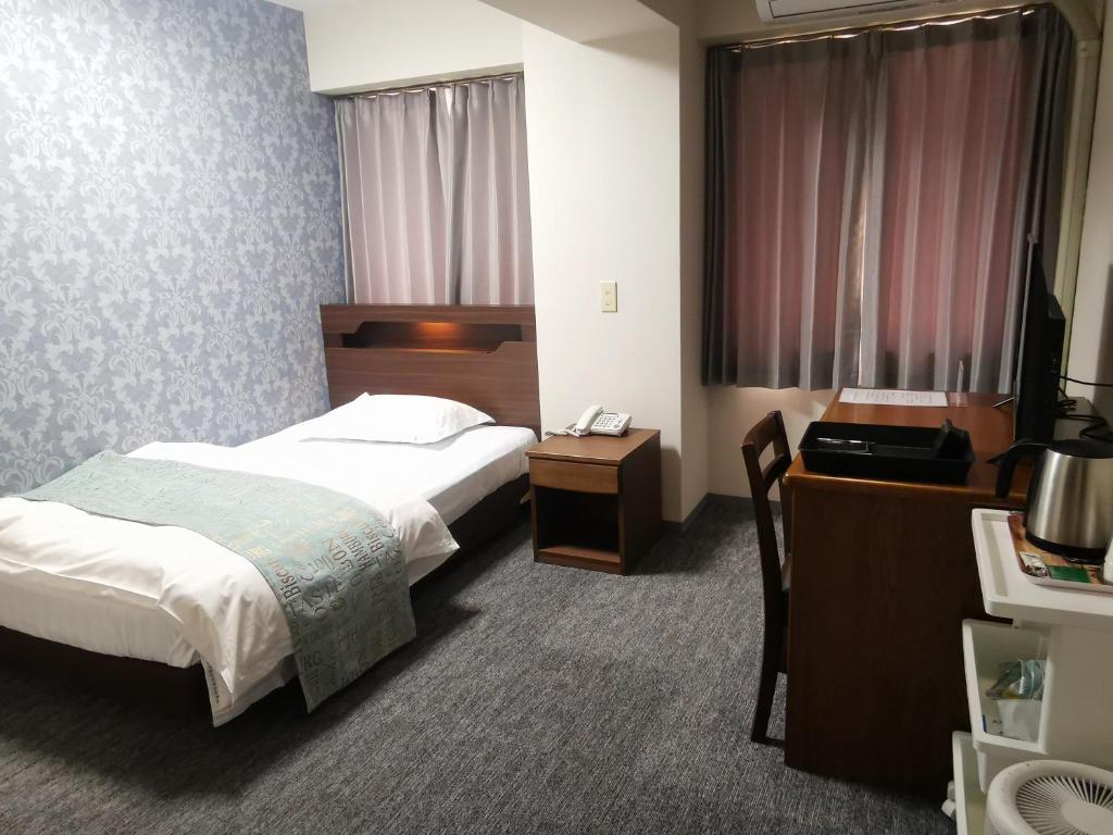 Postel nebo postele na pokoji v ubytování Business Hotel Azuma