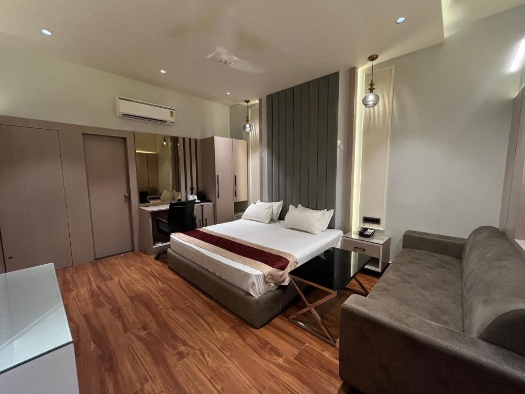 ein Hotelzimmer mit einem Bett und einem Sofa in der Unterkunft Hotel The Seven Inn in Gorakhpur