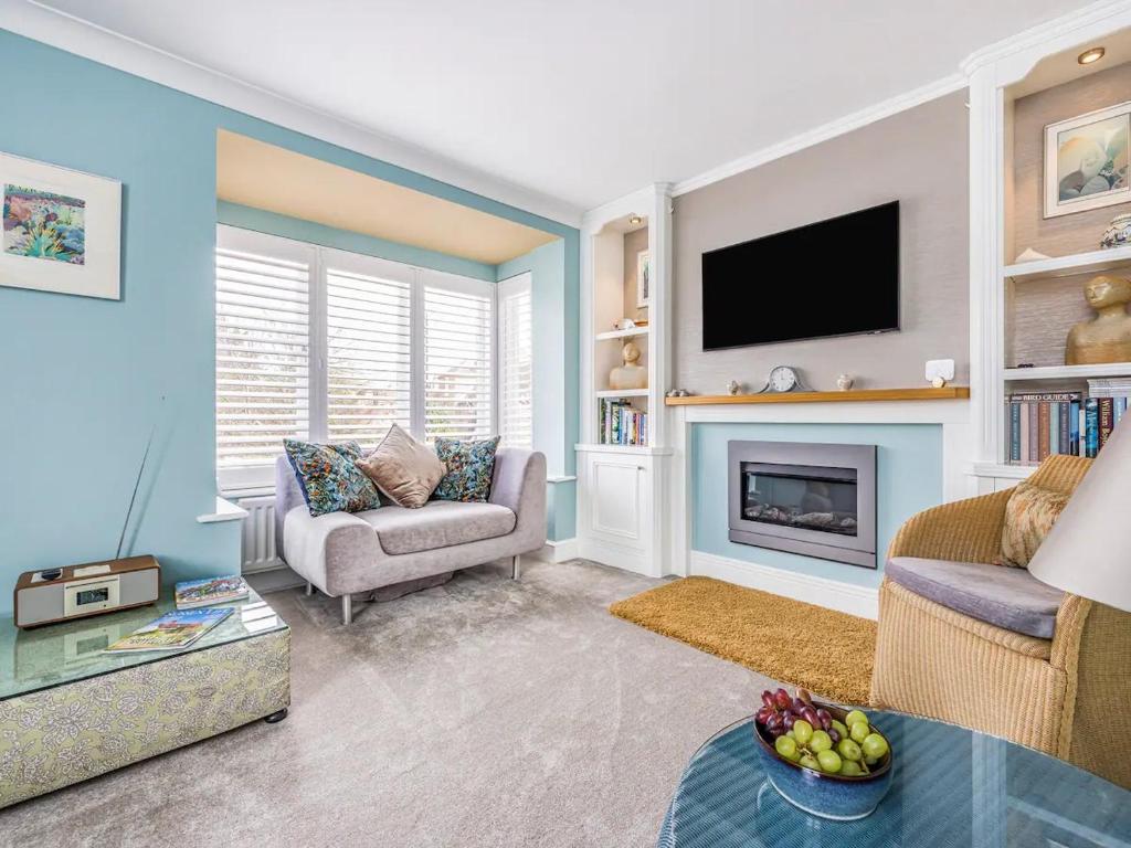 a living room with a fireplace and a tv at Pass the Keys City Centre Town House w Parking in Chichester