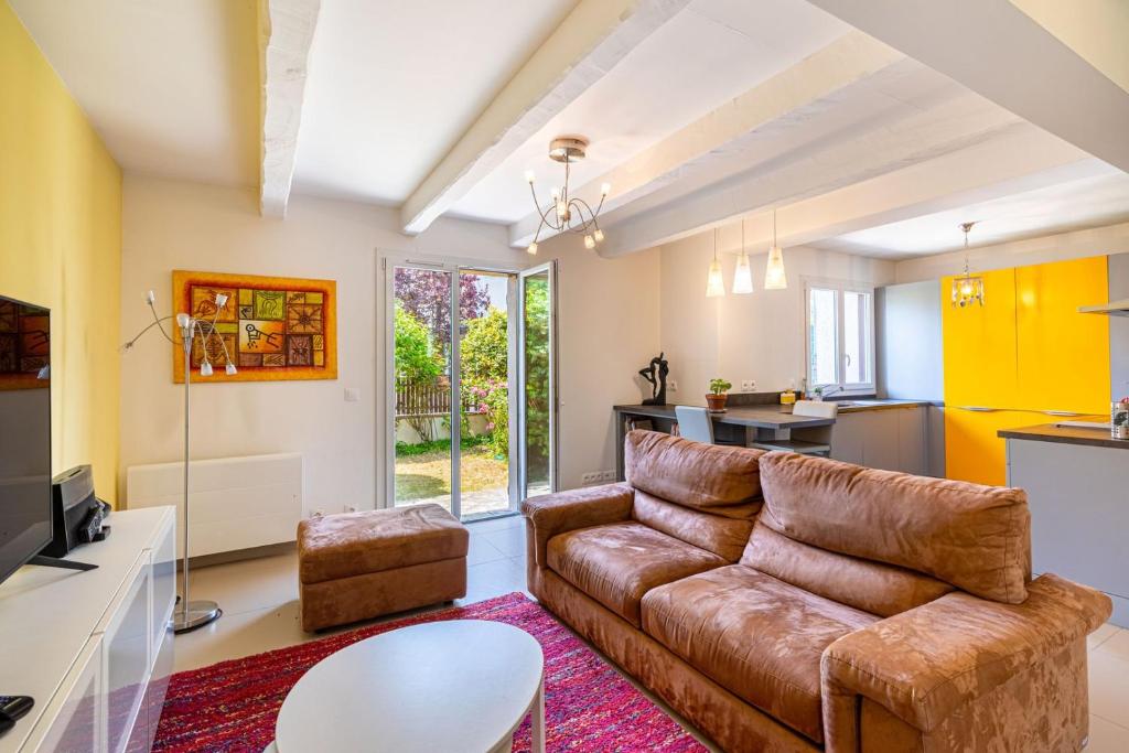 un salon avec un canapé et une cuisine dans l'établissement GuestReady - Fabulous House in Clamart, à Clamart