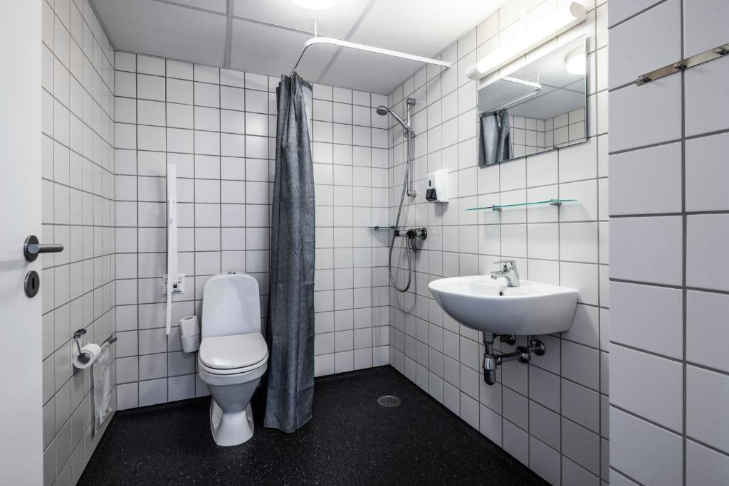 a bathroom with a toilet and a sink at HOTEL SØMA Ilulissat in Ilulissat