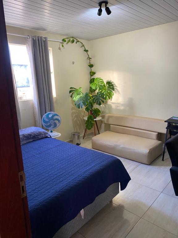 Un dormitorio con una cama azul y una planta en Nosso lar em Natal - quarto, en Natal
