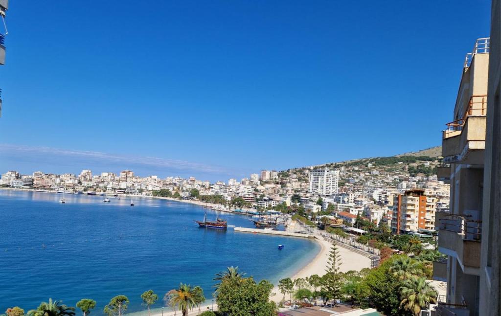 a view of a city with a beach and a harbor at Heraklius Apartament in Sarandë