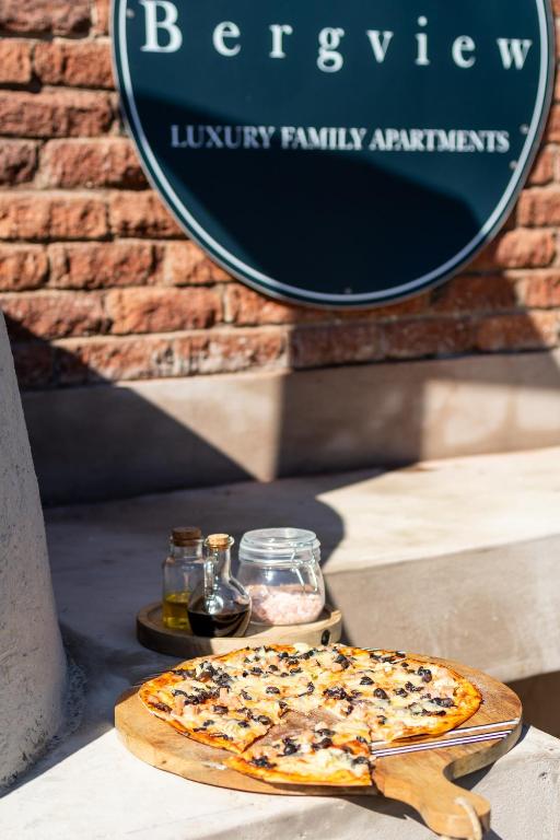 a pizza sitting on a table in front of a sign at 24 Bergview Road apartment in Hilton