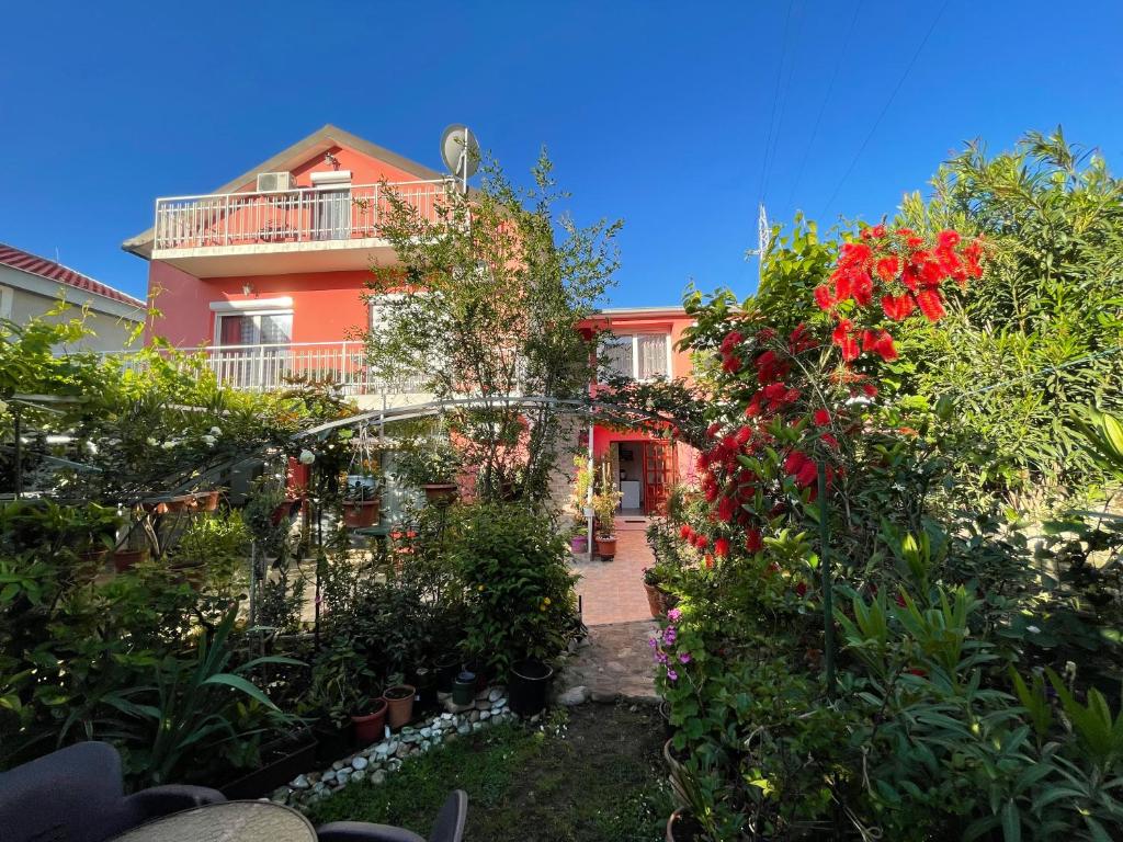 a house with flowers and plants in front of it at Studio Max in Bijela