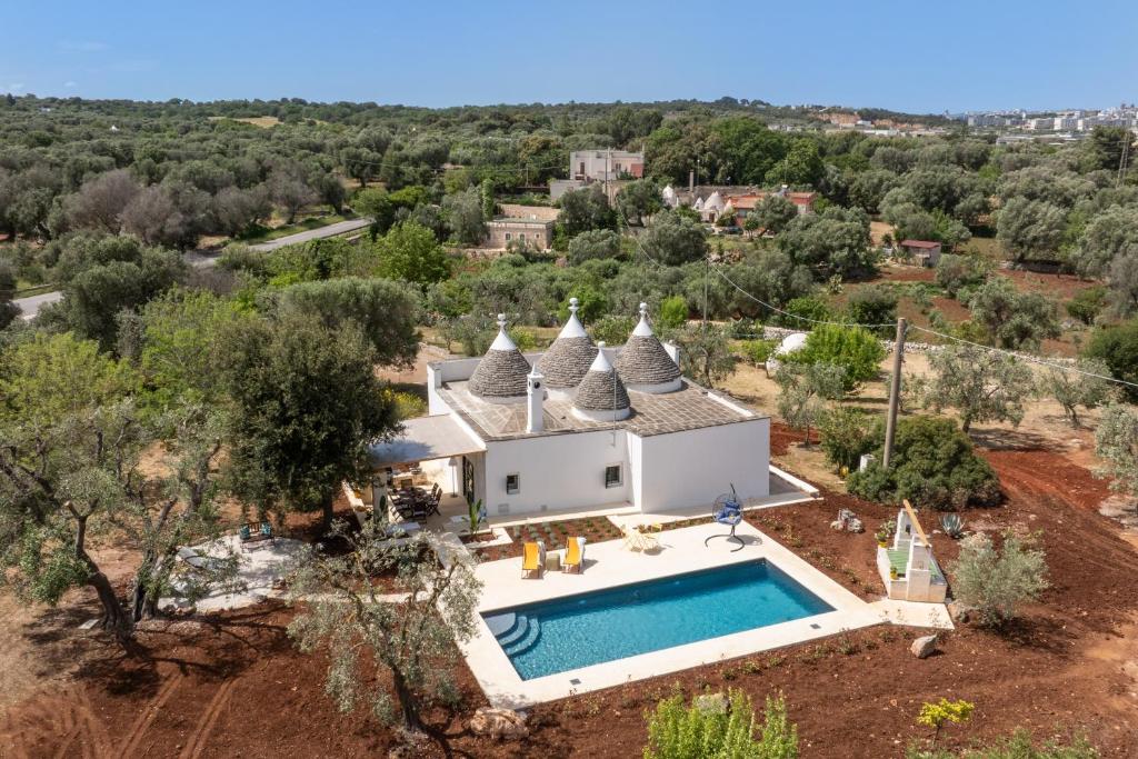 an aerial view of a villa with a swimming pool at Trullo Orto dei Nonni in Ceglie Messapica