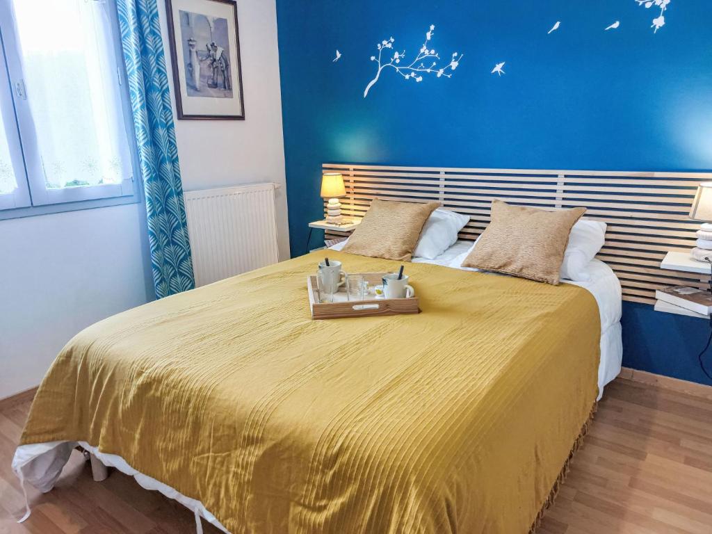 a bedroom with a large bed with a yellow bedspread at Apartment Domaine de Crespin-3 by Interhome in Saint-Gervais-les-Bains