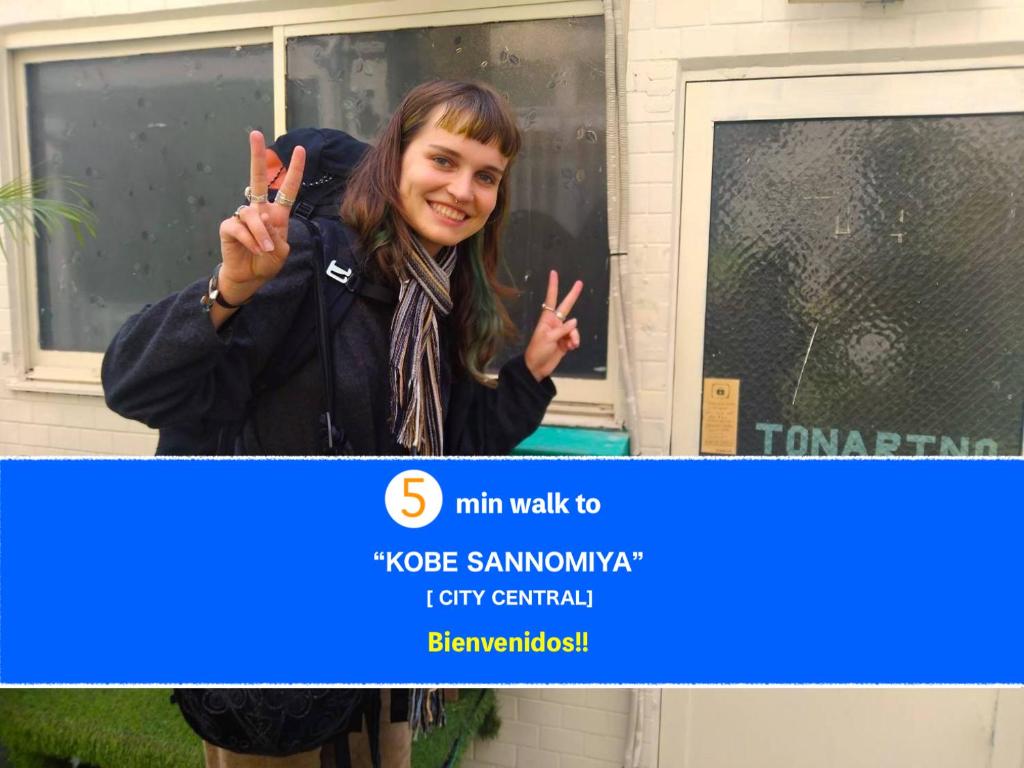 a woman making the peace sign with her hands at TONARINO Hostel for Backpackers in Kobe