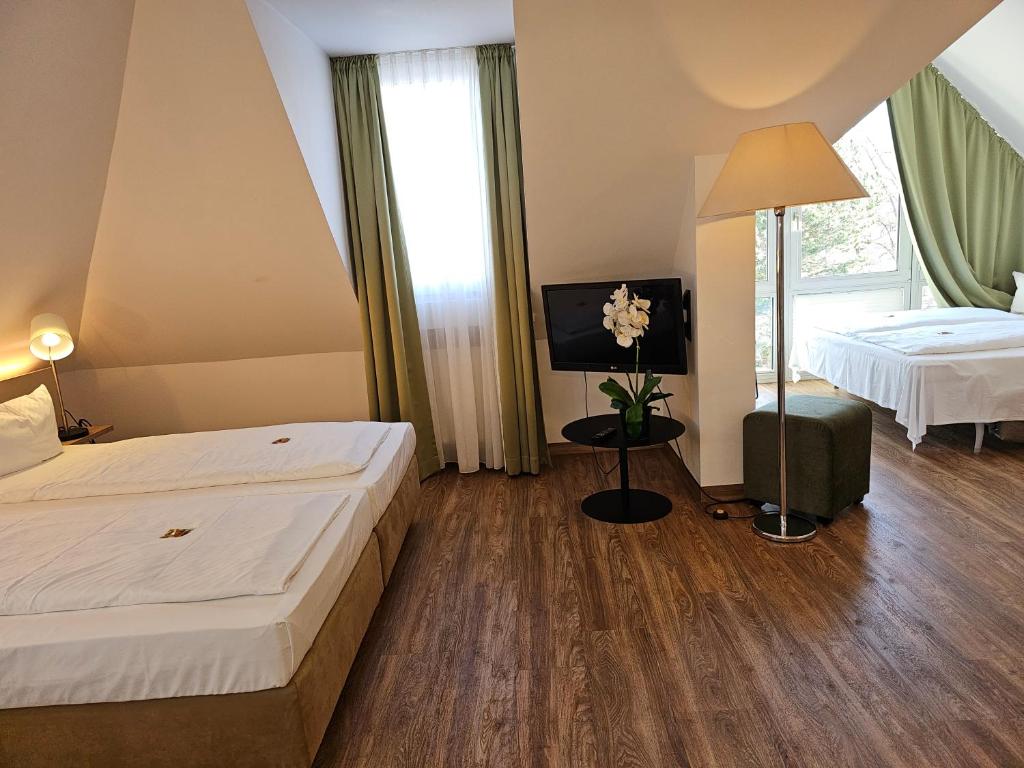Postel nebo postele na pokoji v ubytování Hotel Alpha