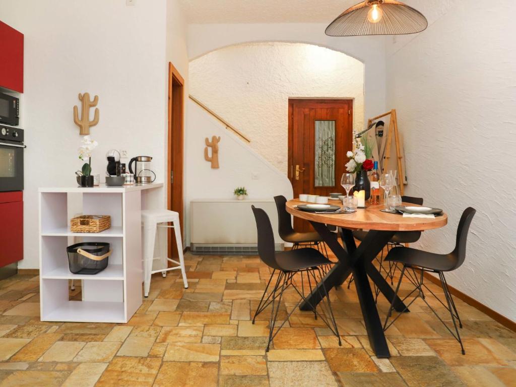 a dining room with a wooden table and chairs at Apartment Le 55Cici by Interhome in Bouveret