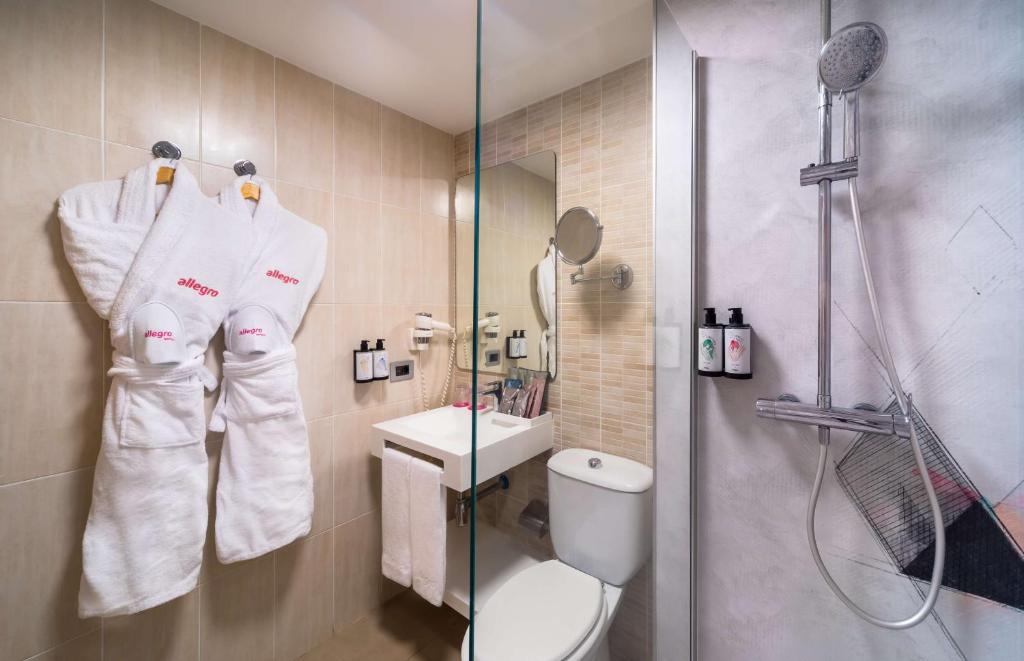 a bathroom with a shower and a toilet and a sink at Allegro Isora in Puerto de Santiago