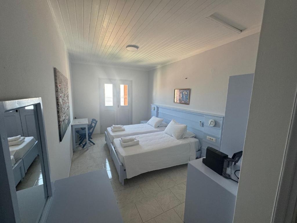 ein großes Wohnzimmer mit einem Sofa und einem Bett in der Unterkunft Hotel Fiona Symi in Symi