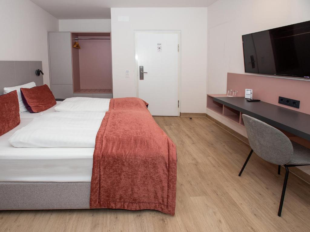 Postel nebo postele na pokoji v ubytování DORMERO Hotel Bargenturm Lüneburg