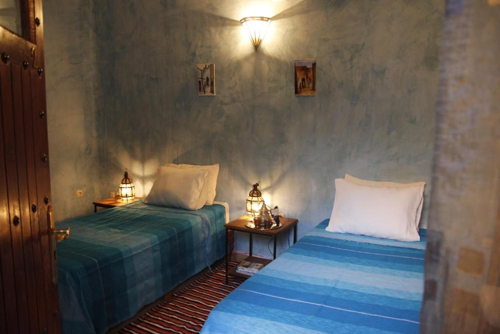 Postel nebo postele na pokoji v ubytování Riad Azenzer