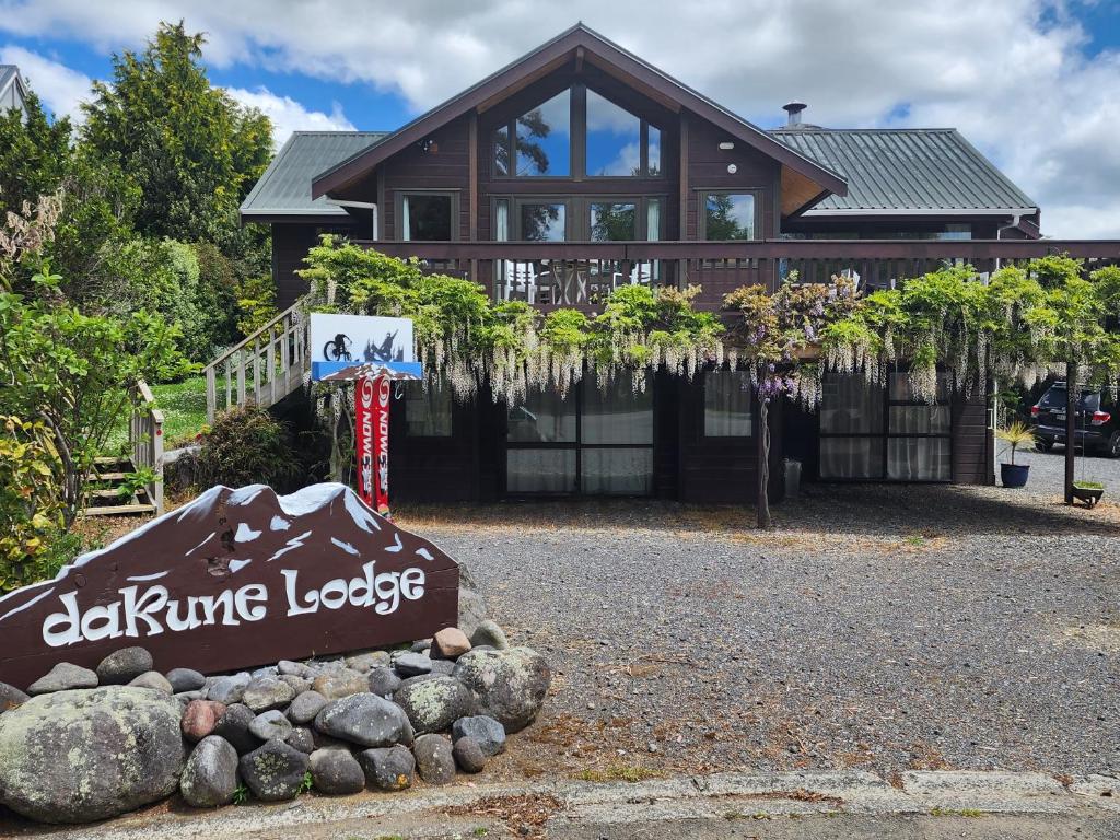 a large house with a sign in front of it at Dakune Chill - The Lodge in Ohakune