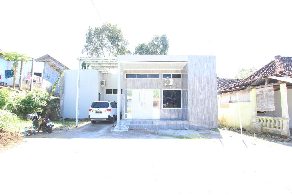 a white car parked in front of a house at Capital O 93939 Oikodomeo in Salatiga