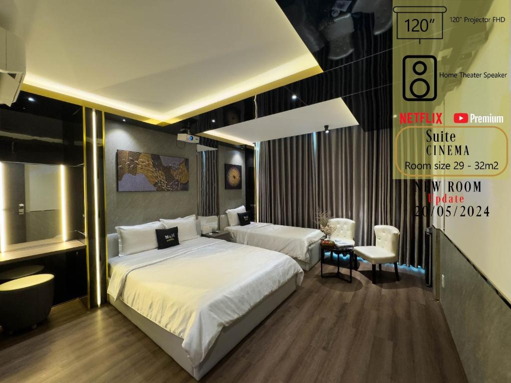 a bedroom with two beds and a sign on the wall at M&H Hotel in Ho Chi Minh City