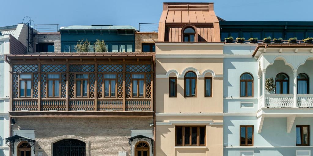 a building with a balcony on top of it at Puris Moedani Boutique Hotel in Tbilisi City