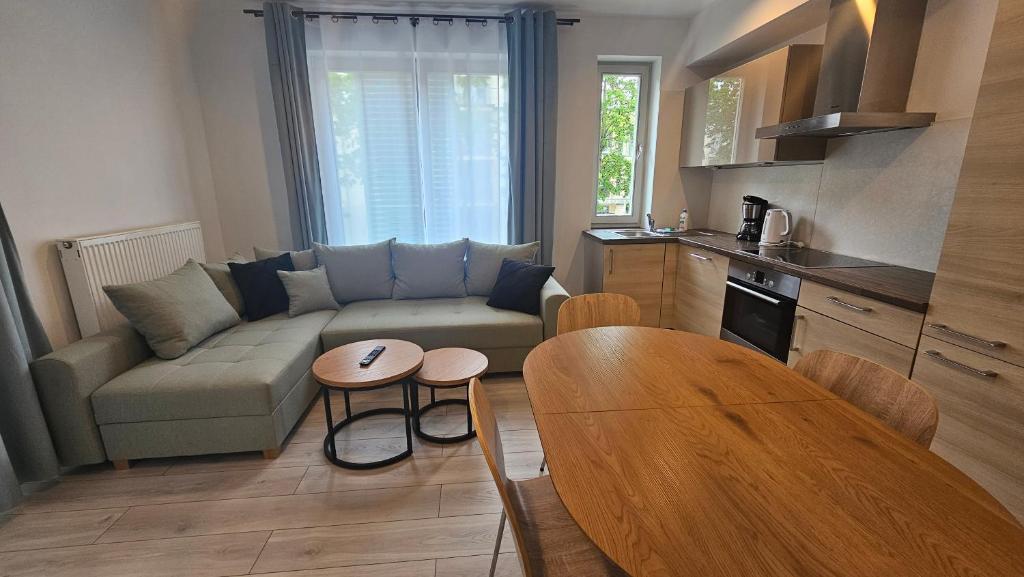 a living room with a couch and a table at Casa Marina Apartament Familijny Premium in Świnoujście