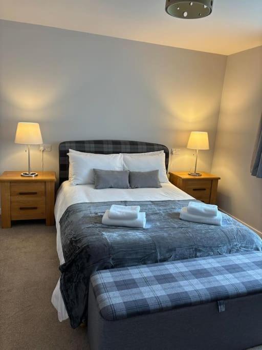 a bedroom with a large bed with two night stands at Havrock in Orkney